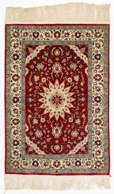 A silk Hereke rug, circa 91 x 63 cm.