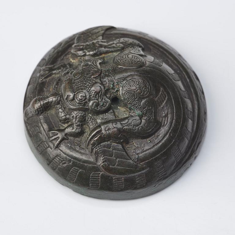 A bronze dragon a and bird weight, Warring states (475–221 BC).