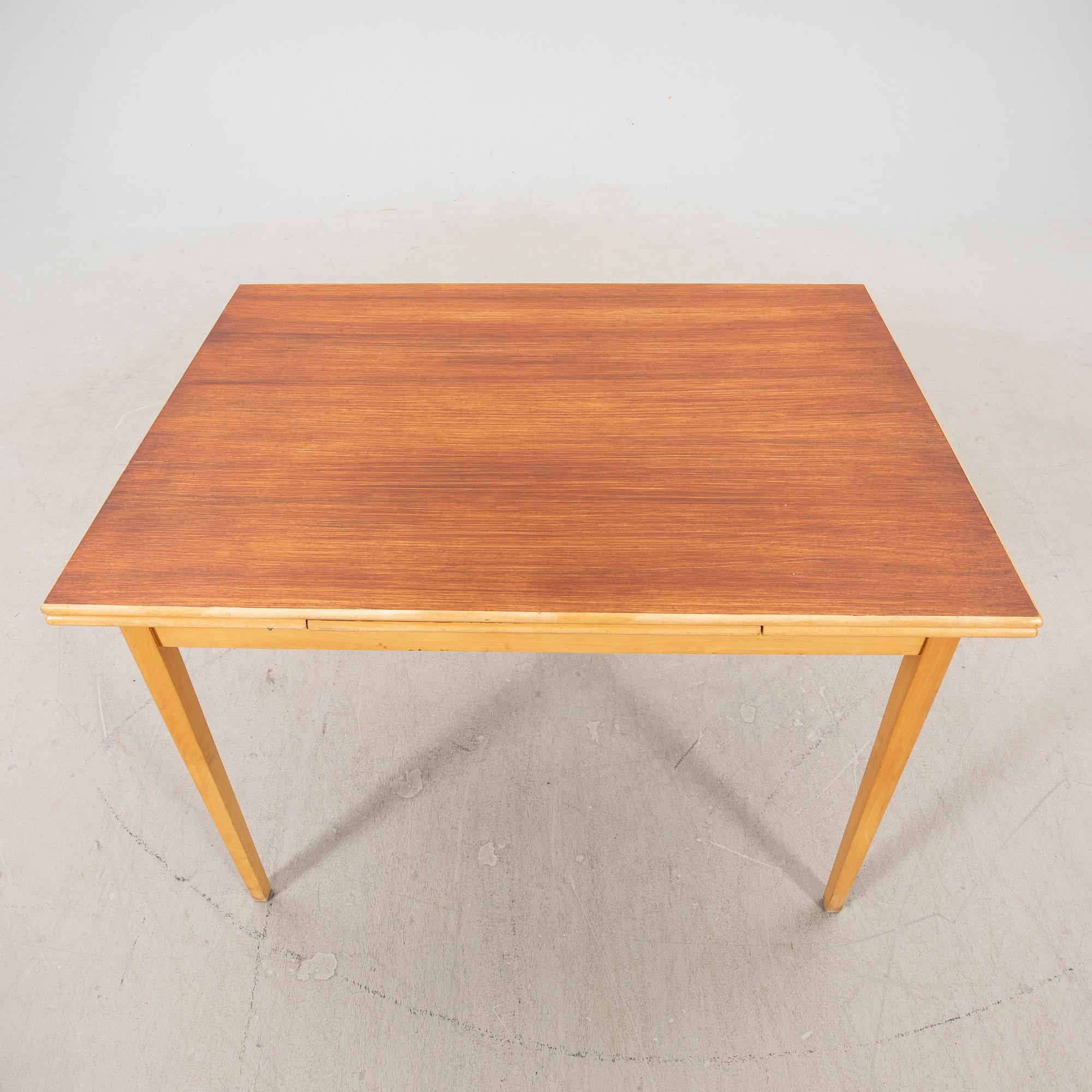 A 1960s teak and beech dining table.