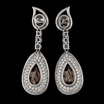 A pair of fancy yellow diamond earrings, 8.88 cts, resp. 8.88 cts each, and smaller white brilliant cut diamonds.