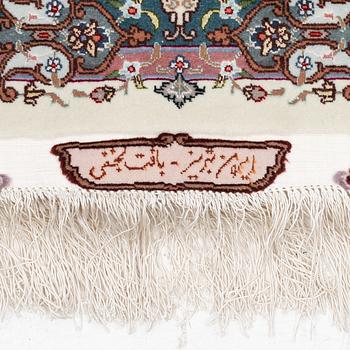 A Tabriz carpet, 210 x 195 cm. signed.
