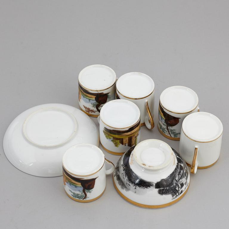 A group of seven cups, one with dish, Germany and France, 19th century.