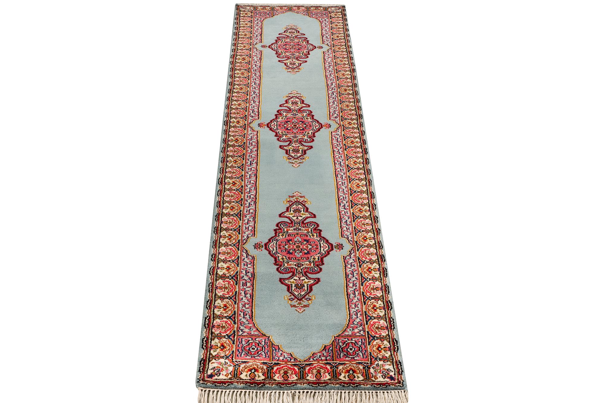 An oriental runner, c. 550 x 74 cm.