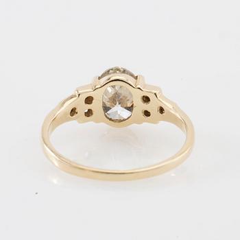 Ring 14K gold with an oval faceted diamond approximately 1.23 ct and round brilliant-cut diamonds.