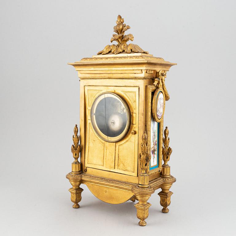 A late 19th century table clock and candelabra, probably France.