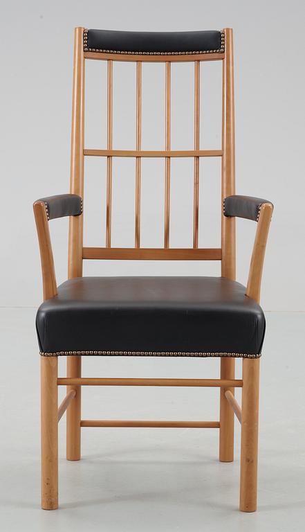 A Josef Frank cherrywood and black leather armchair by Svenskt Tenn, model 652.