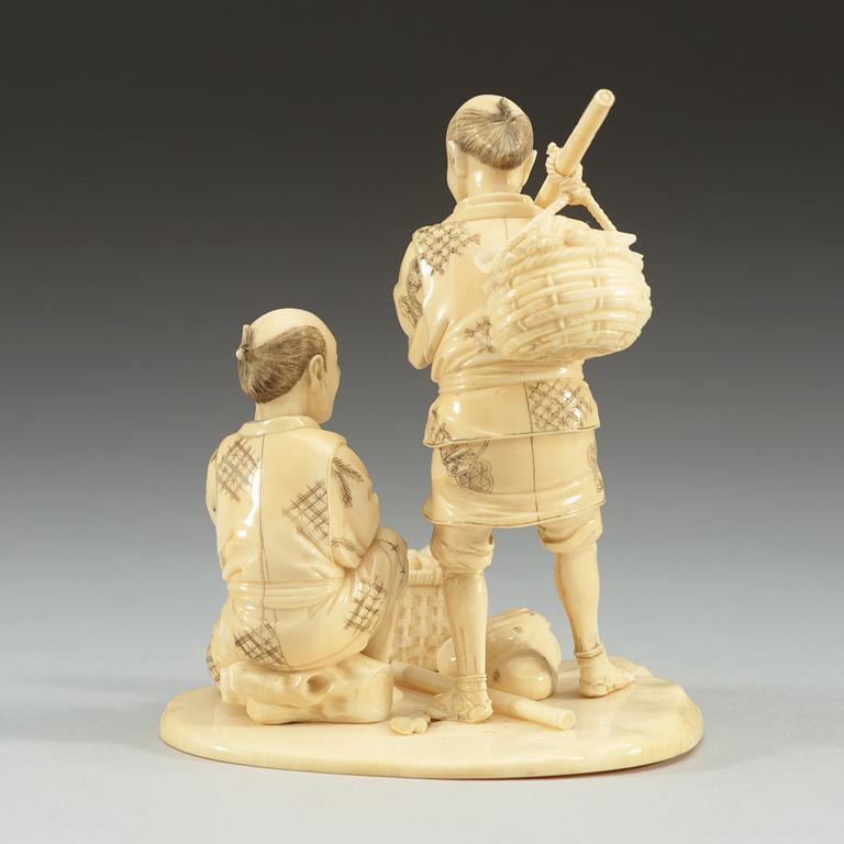 A Japanese ivory sculpture of two men, period of Meiji (1868-1912). Signed.