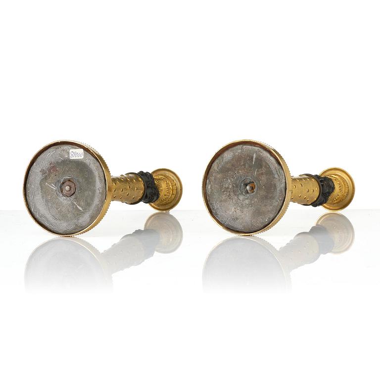 A pair of Napoleon III gilt and patinated bronze candlesticks, later part 19th century.