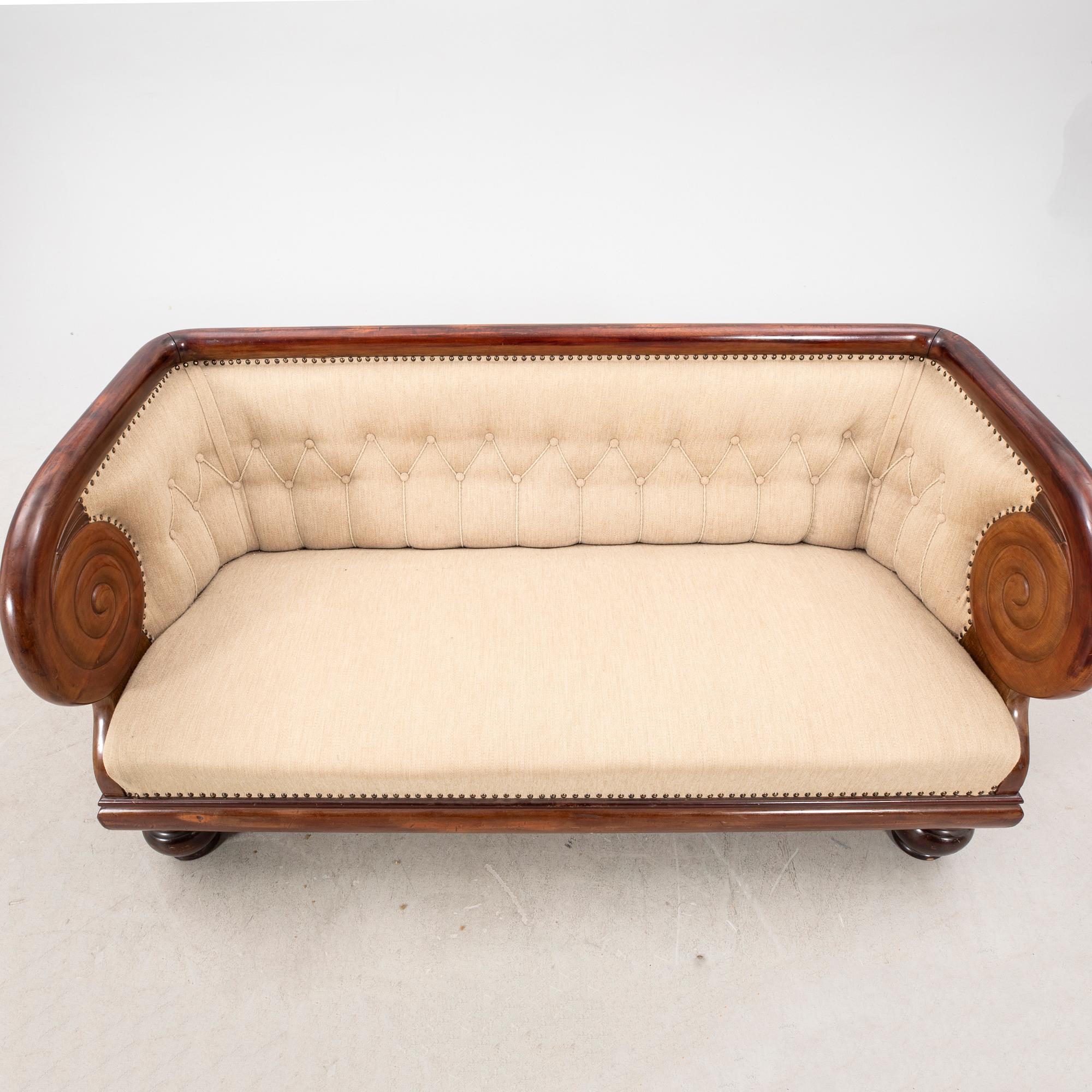 An early 1900s Art deco walnut sofa.