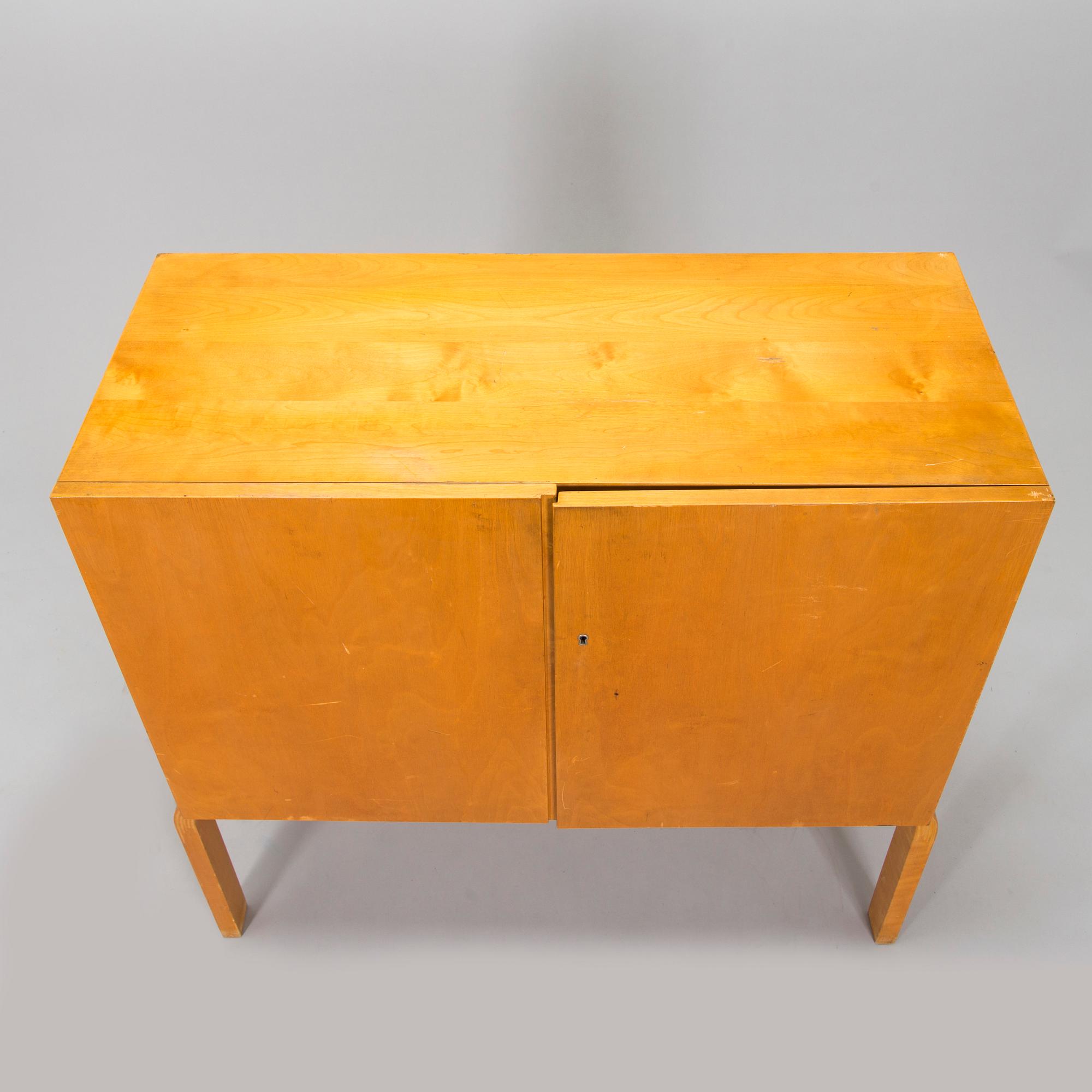 Alvar Aalto, mid-20th century '810' cabinet and a 
'69'chair Oy Huonekalu- ja Rakennustyötehdas Ab.