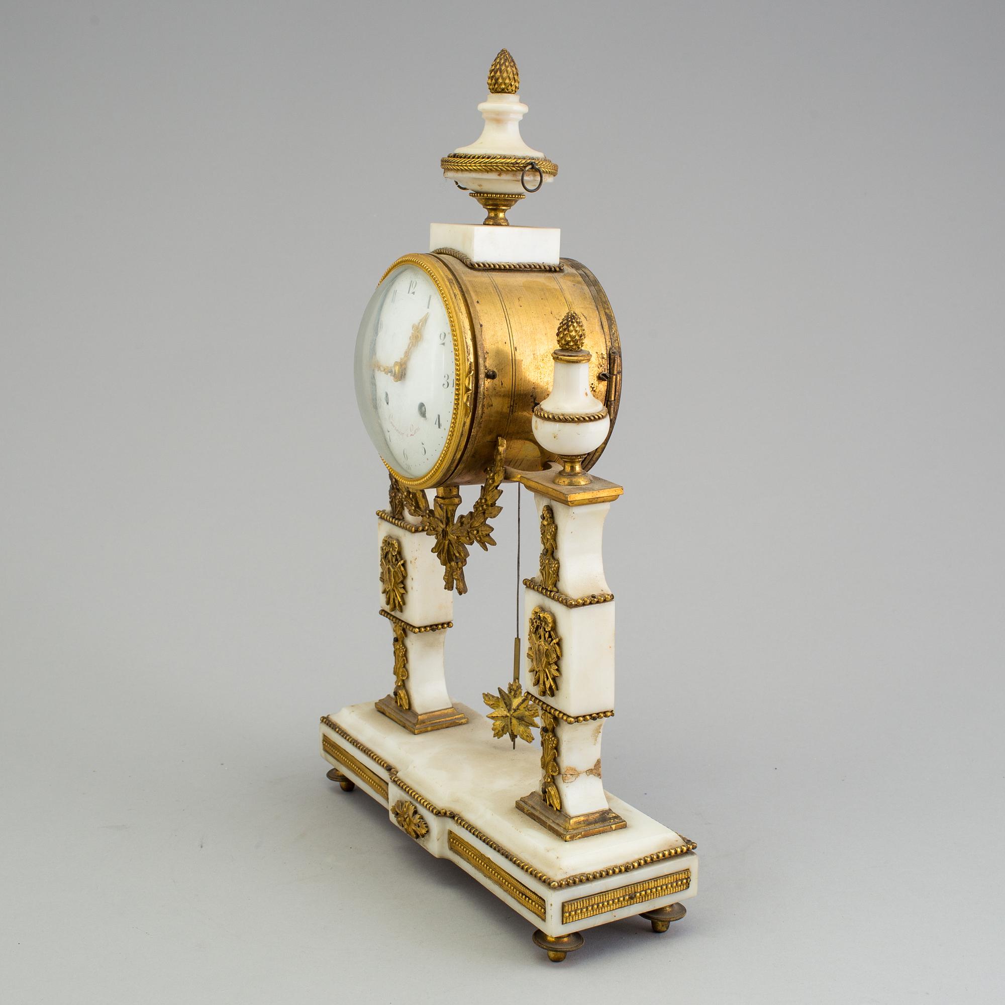 A Louis XVI marble and bronze mantel clock from the second half of the 18th century.