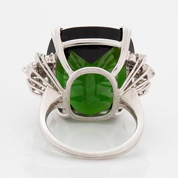 An 18K white gold ring set with a green tourmaline and round- and marquise brilliant-cut diamonds.