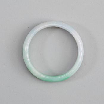 A white and green jadeite bangle with traces of lavender colour, China, 20th Century.
