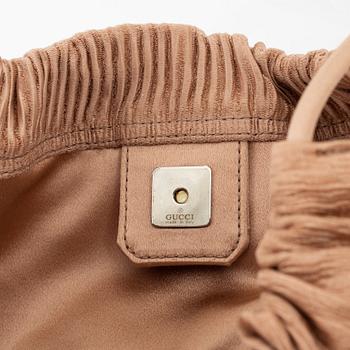Gucci, a textile handbag.