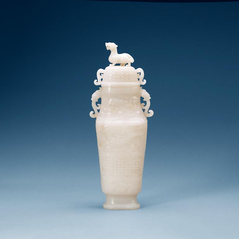 A archaistic carved white stone vase with cover.