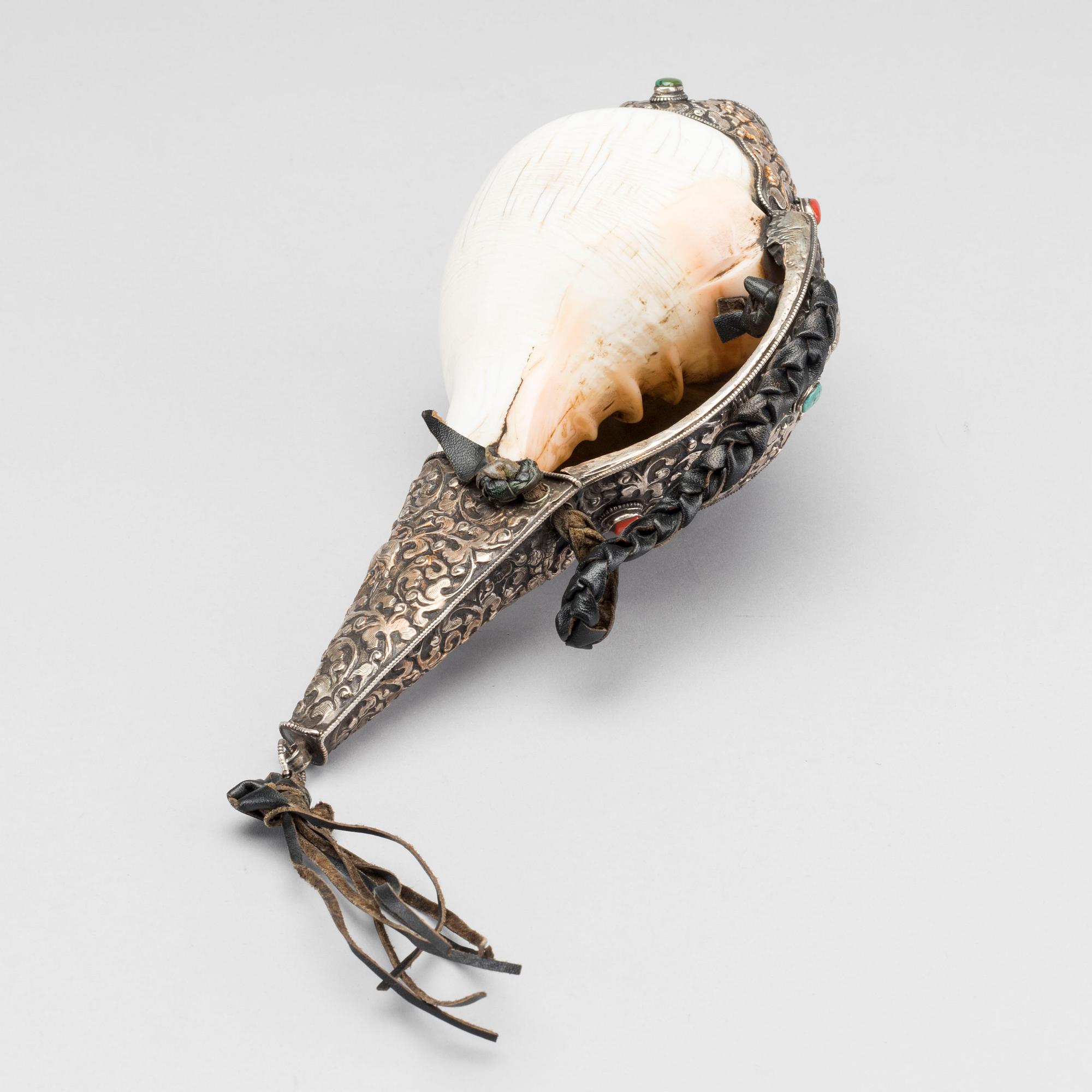 A elaborately decorated ritual Tibetan Conch-shell horn.