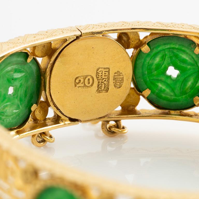 Gold bangle with green stone, possibly jadeite.