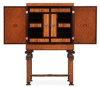 An Erik Matsson marquetry cabinet on stand, Carl Johansson Möblering AB, Stockholm 1932.