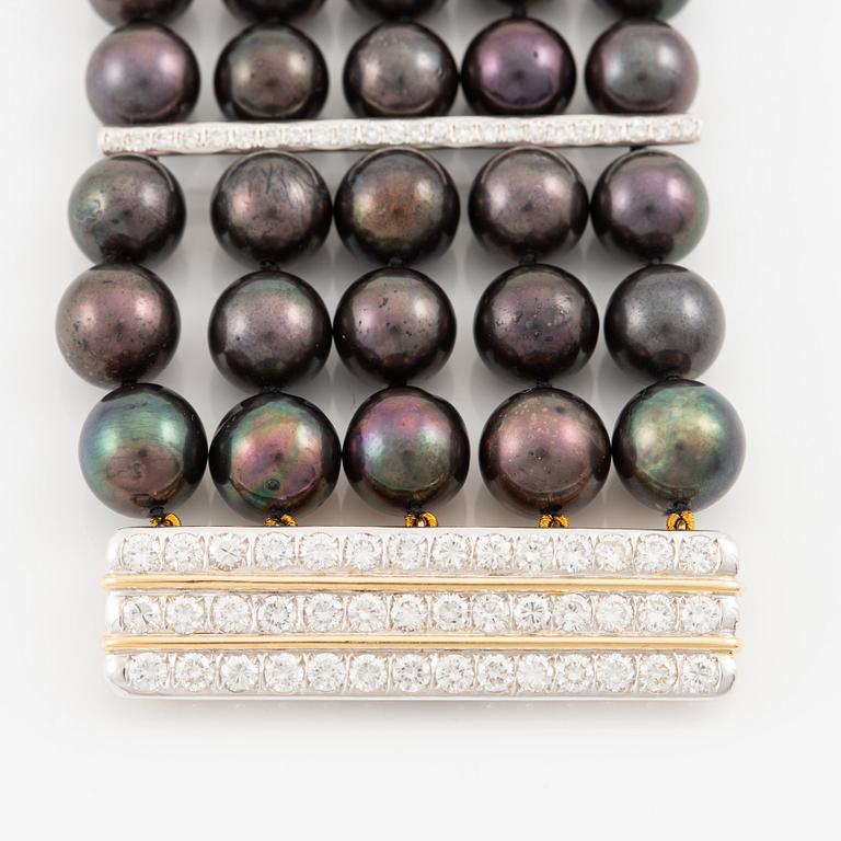 Bracelet with five rows of cultured black pearls, clasp in 18K gold and white gold set with brilliant-cut diamonds.