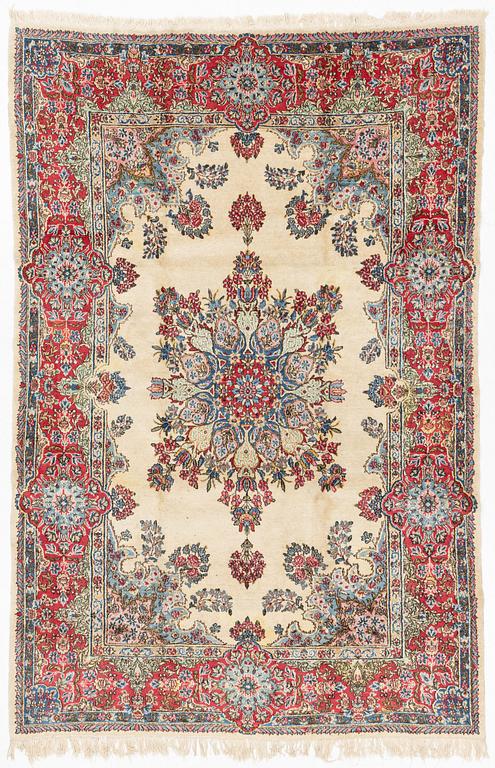 A carpet, old Kerman, approx. 314 x 210 cm.