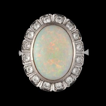 37. An opal, 9.97 cts, and diamond, 1.00 ct, ring. Weights according to engraving.