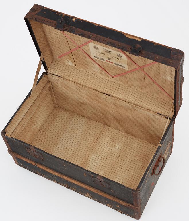 A late 19th century black trunk by Louis Vuitton.