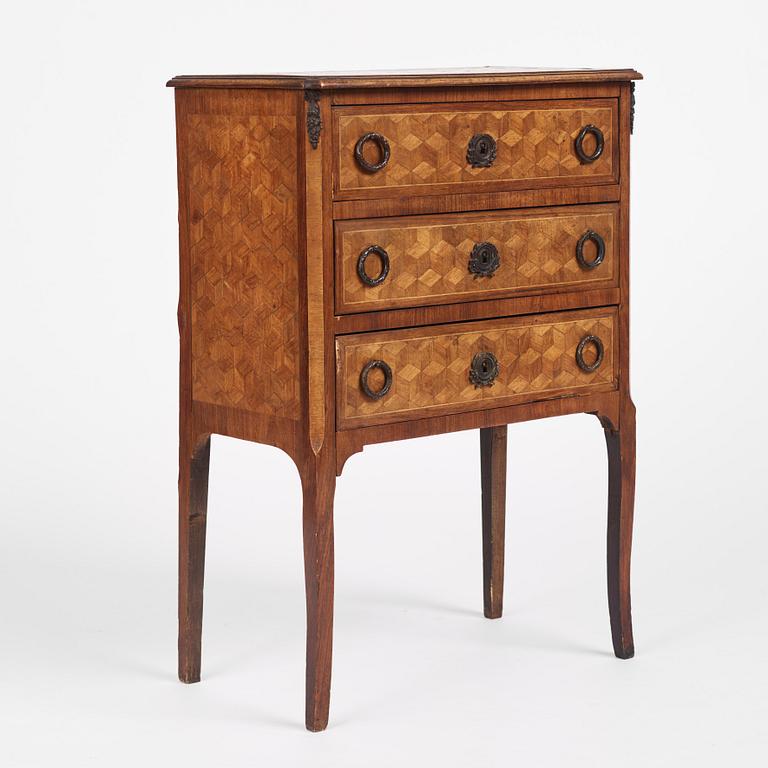 A Louis XVI-style parquetry commode, circa 1900.