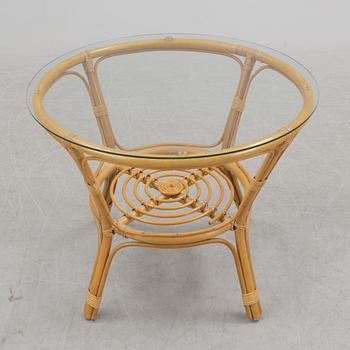 A 1970s four piece set of rattan garden furniture.