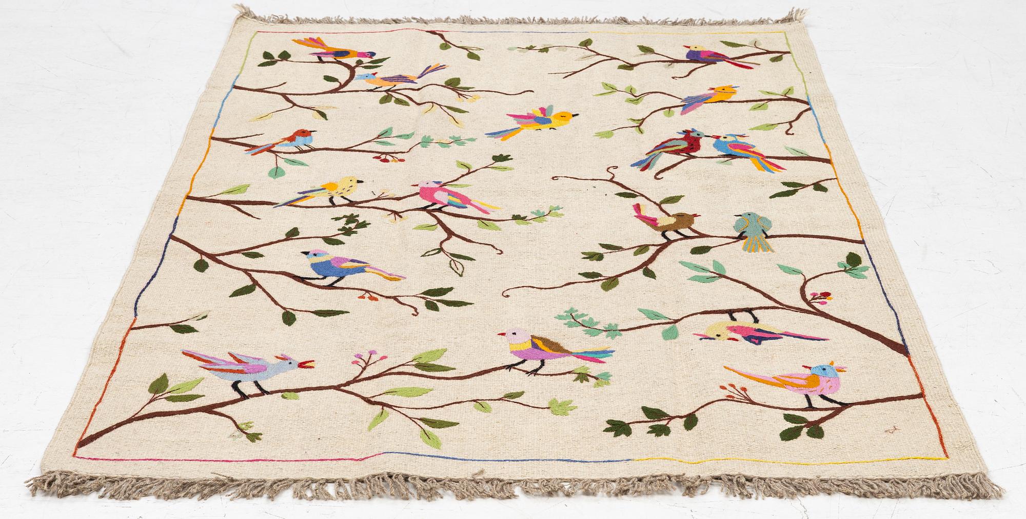 A hand-embroidered kelim rug, c. 183 x 125 cm.