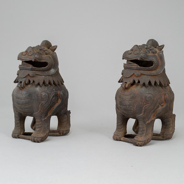 A pair of Chinese iron Fo dogs, 20th Century.
