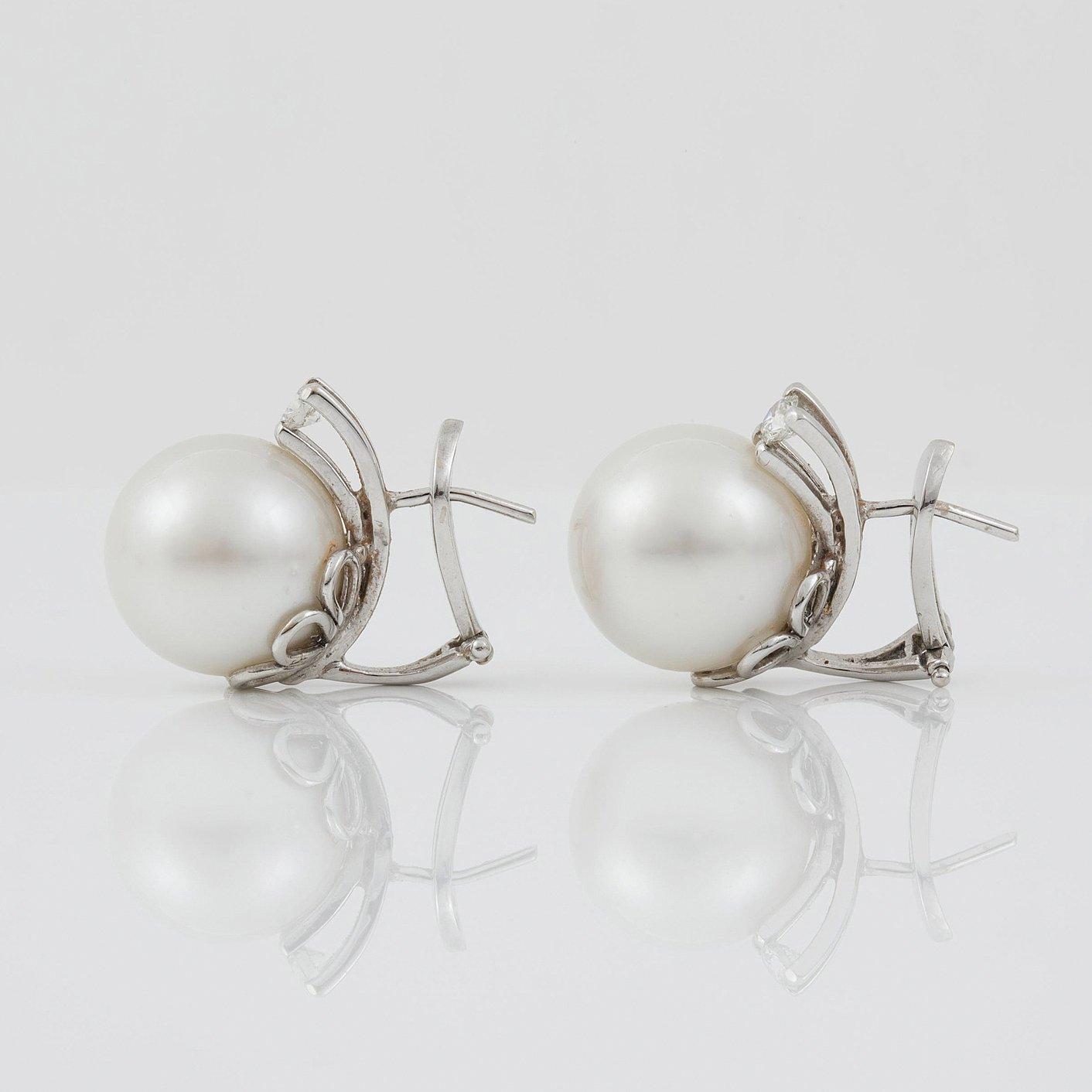 A pair of cultured South sea pearl and diamond earrings. Total carat weight of diamonds circa 0.35 ct.