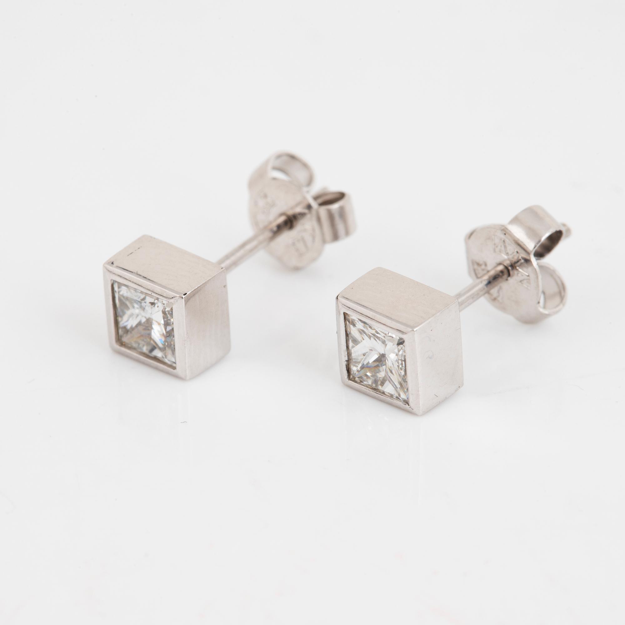 A pair of square modified brilliant cut diamond earrings.