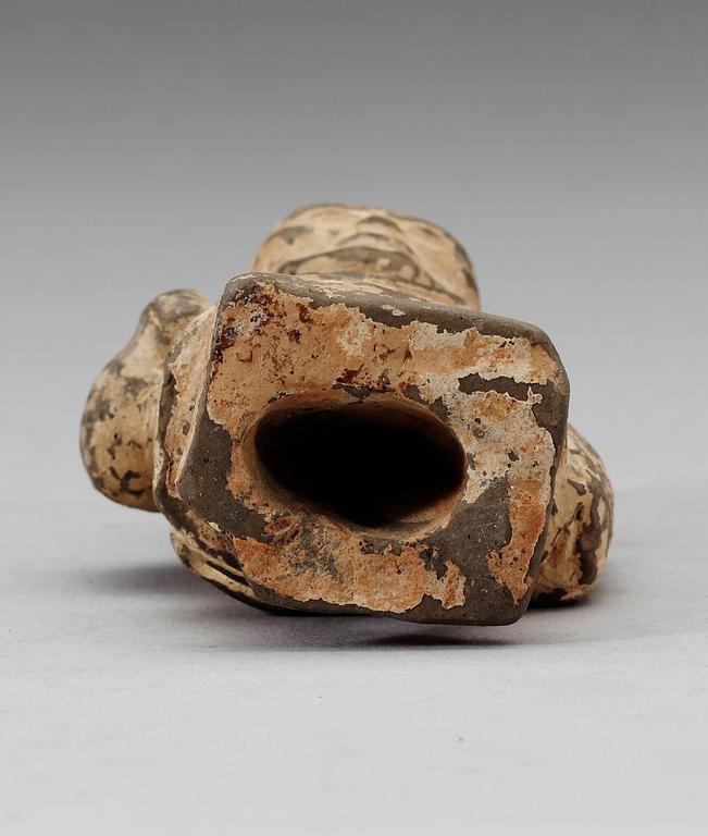 A small potted figure of a man, Han dynasty (206 BC - 220 AD).