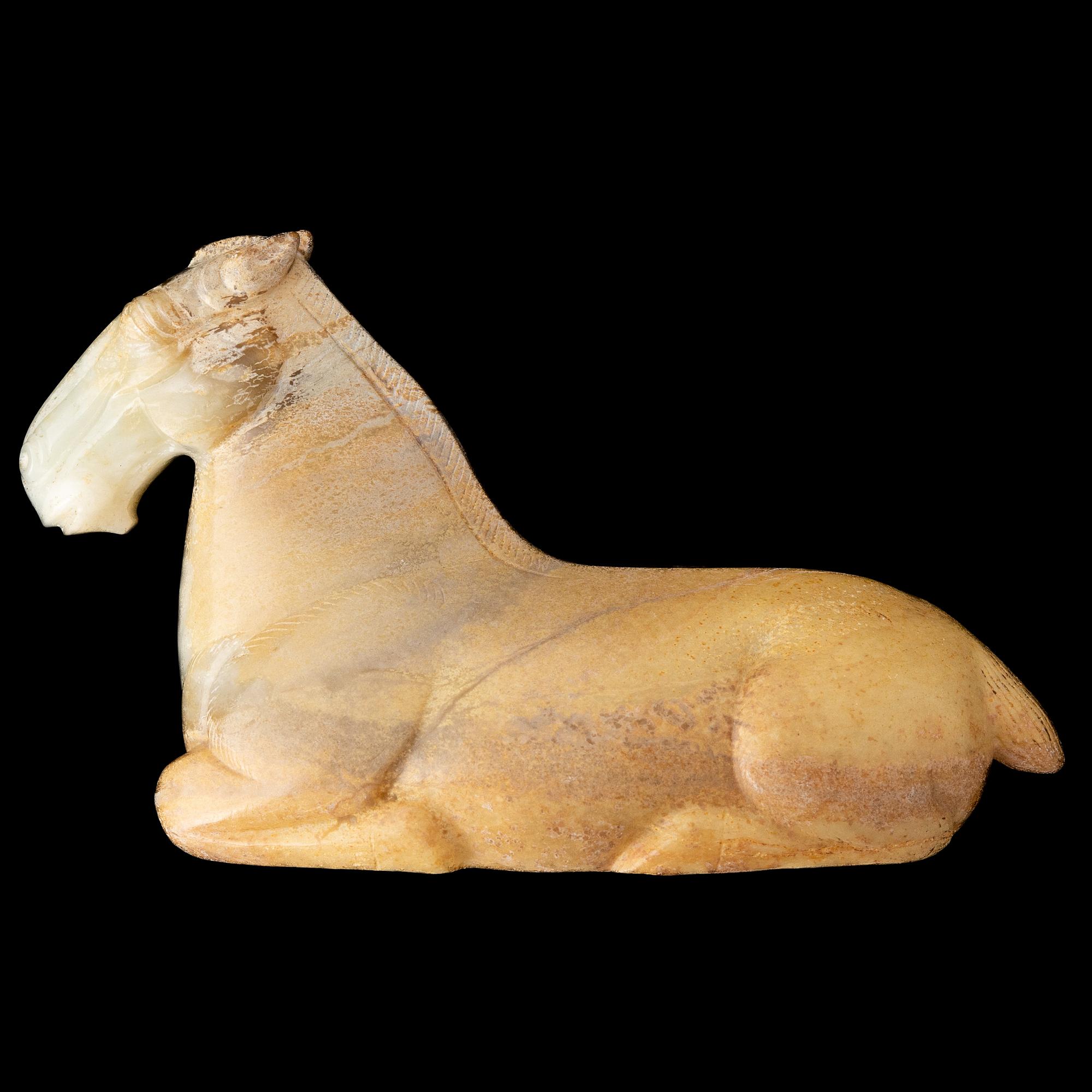 A carved nephrite figure of a reclining horse, 20th Century.