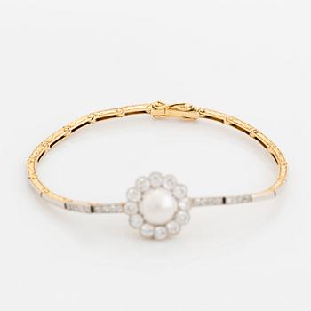 A gold and platinum bracelet with a bouton pearl and set with old- and eight-cut diamonds.