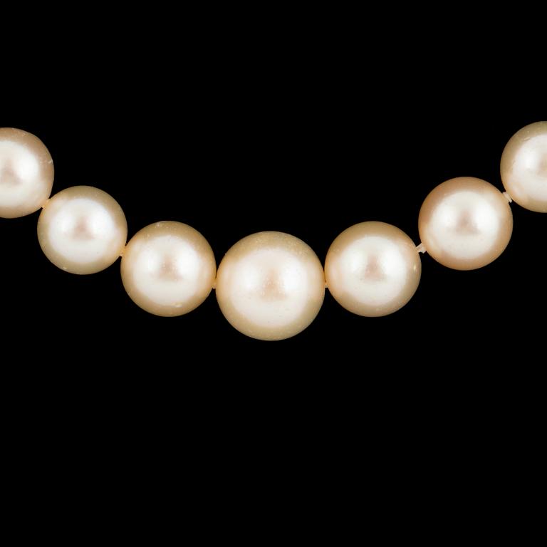 Cultured calibrated pearl necklace, clasp with emerald and old-cut diamonds.