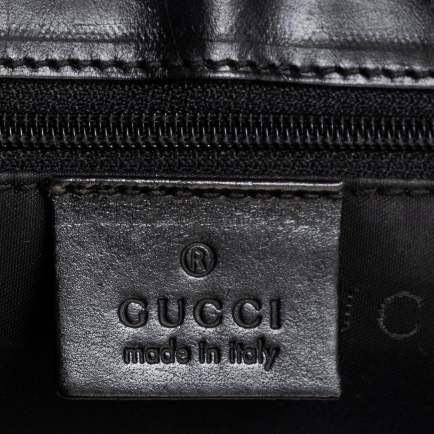 GUCCI, a leather and canvas bag.