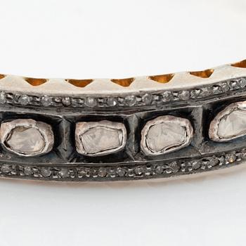 A faceted diamond bangle.