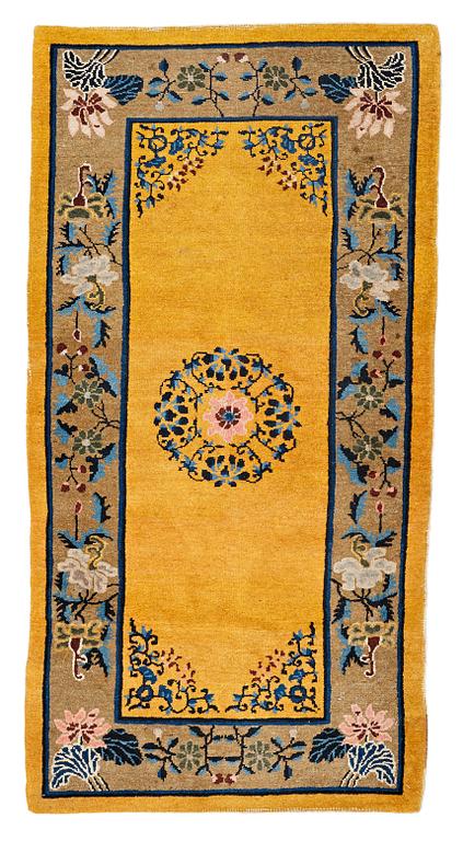 A RUG, an old China, ca 177,5 x 92,5 cm.