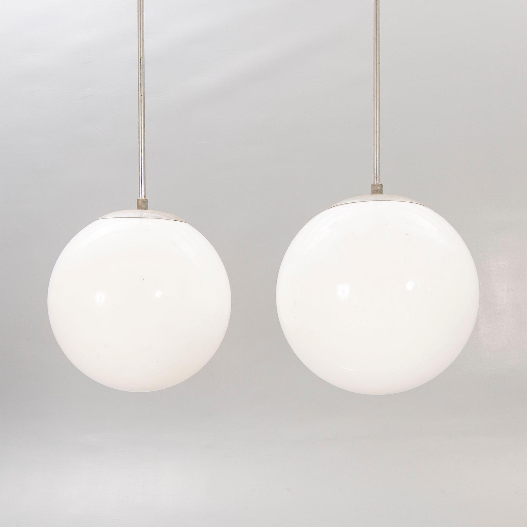 A pair of 1930s glass and chromed ceiling lights.