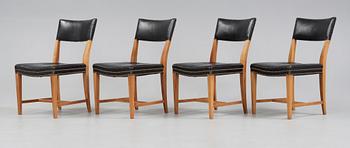A set of four Josef Frank walnut and black leather chairs, Svenskt Tenn, model 695.