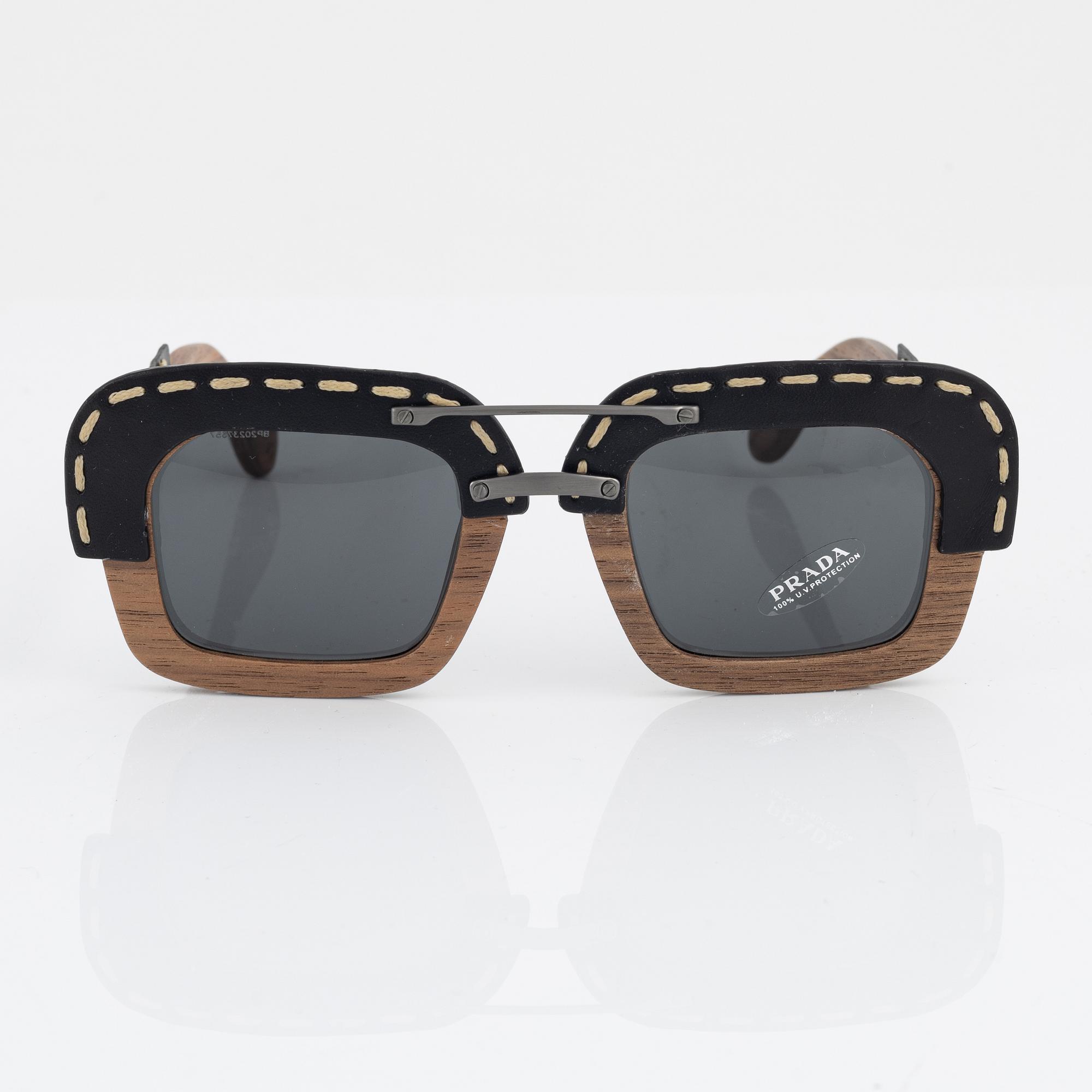 Prada a pair of wood and leather sunglasses. Bukowskis