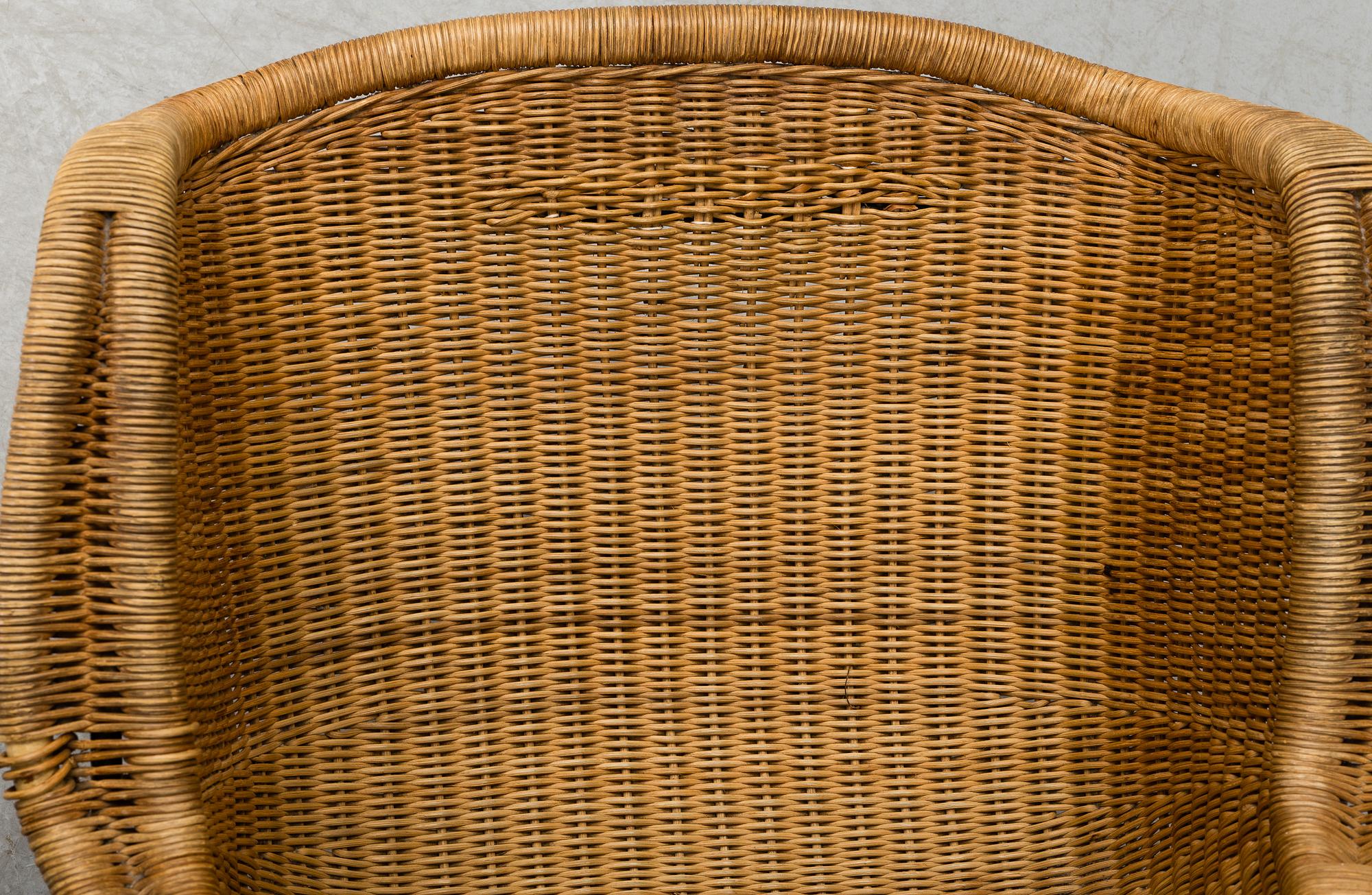 A 1950's pair of rattan easy chairs.