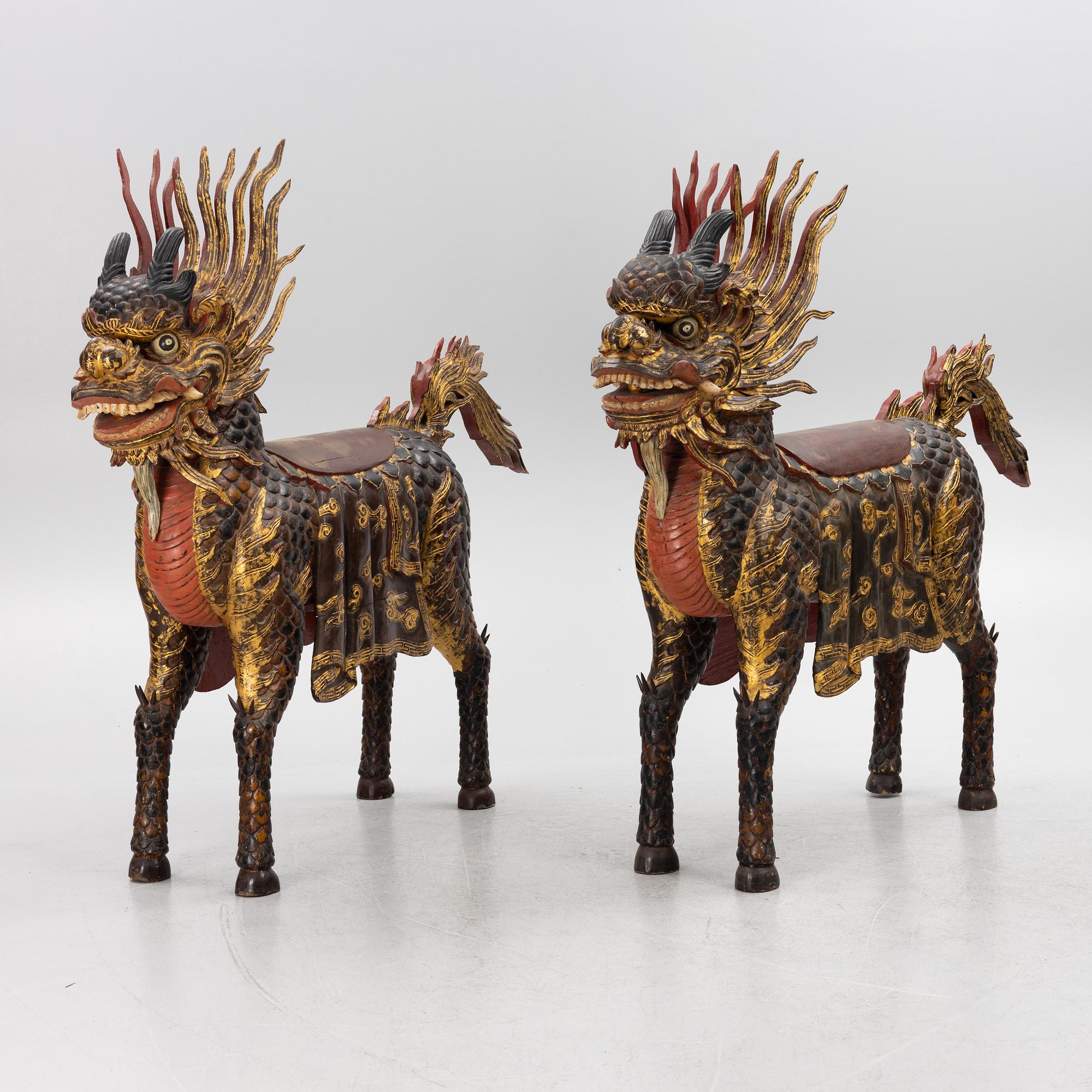 A pair of large Qilin sculptures, lacquered wood, first part of the 20th century.
