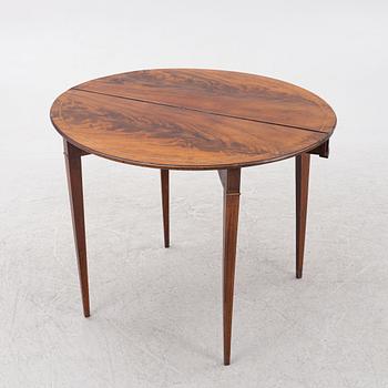 A mahogany-veneered table, presumably Denmark, Empire, first half of the 19th century.