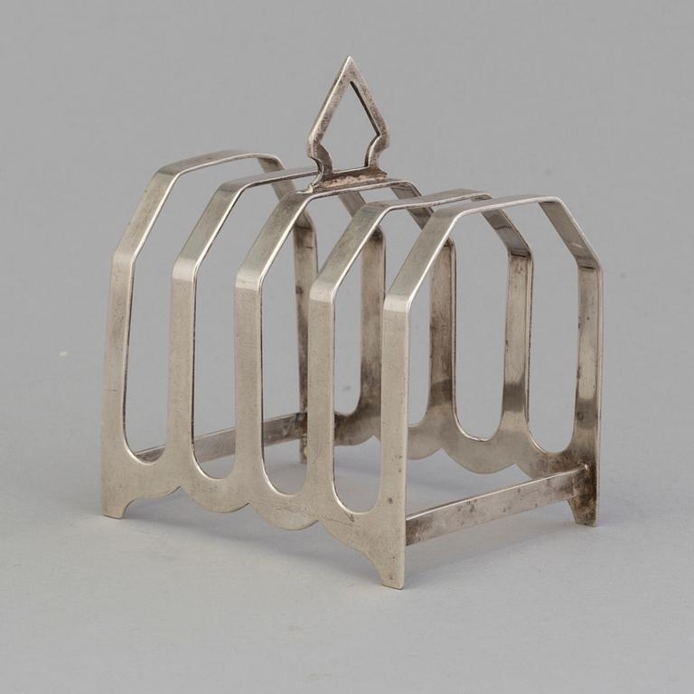 A silver toast rack from J. Gloster Ltd, Birmingham, England, 1933.