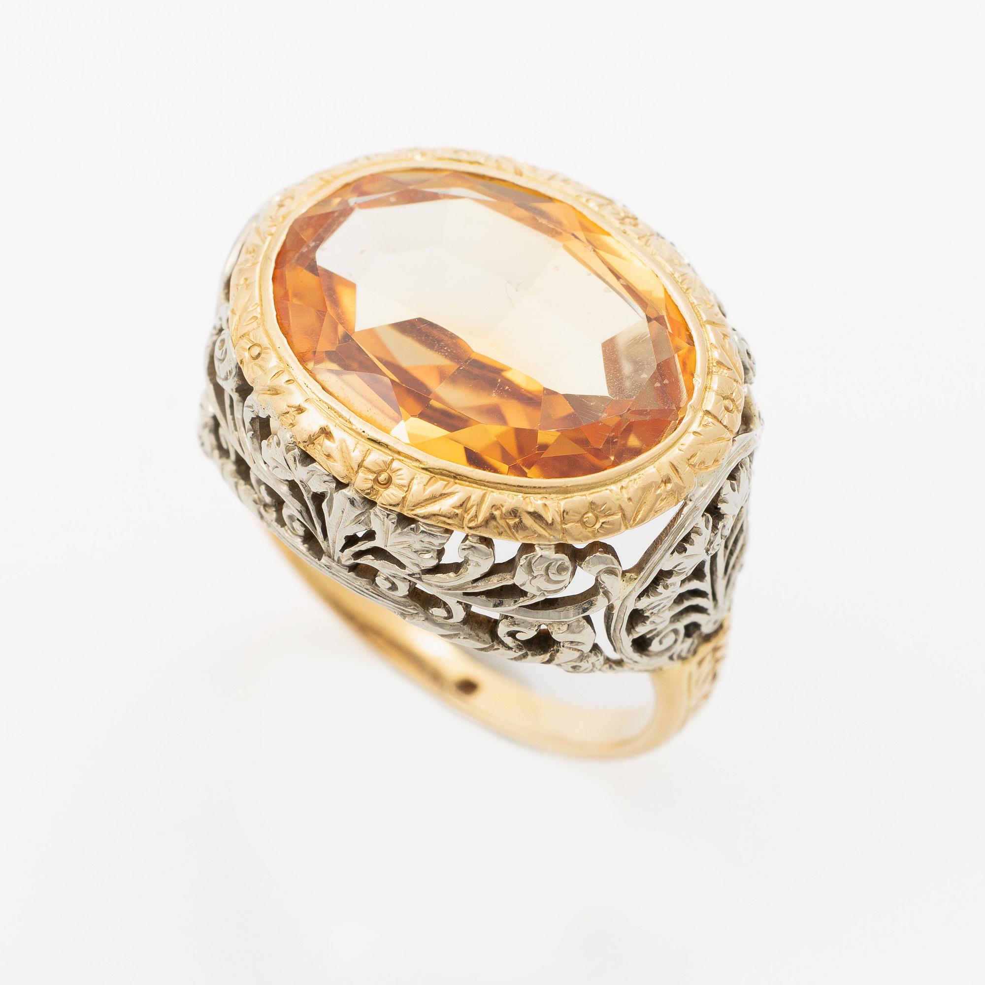 Gold ring with synthetic yellow sapphire.