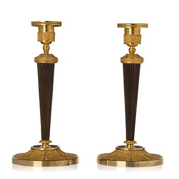 177. A pair of Empire ormolu and patinated bronze candlesticks.