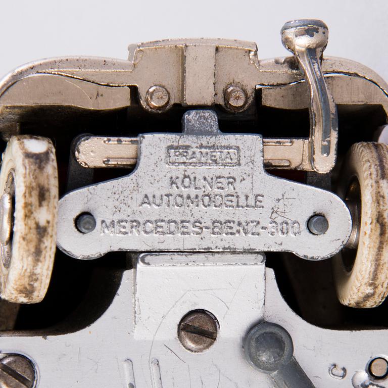 Two mid-20th century toy cars, chromed metal and wood.