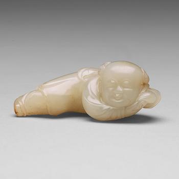 491. A nephrite figure of a reclining boy holding a lingzhi fungus, 20th Century.